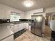 Bright kitchen features white cabinets, stainless steel refrigerator, neutral counters and eat-in breakfast area at 4257 Webb Rd, Tucker, GA 30084