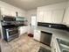 Galley kitchen features stainless appliances and white cabinets at 4257 Webb Rd, Tucker, GA 30084