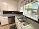 This kitchen features a stainless-steel sink and a window with a view of the outdoors at 4257 Webb Rd, Tucker, GA 30084
