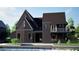 Beautiful new construction home with a second story balcony and front patio at 100 Carlyle Ln, Fayetteville, GA 30214