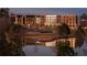 Scenic exterior view of a complex featuring a pond reflecting the building at 100 Carlyle Ln, Fayetteville, GA 30214