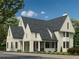 Striking exterior view of a two-story home with dark gray roof and cream-colored siding, showcasing its modern design at 100 Carlyle Ln, Fayetteville, GA 30214