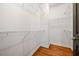 Walk-in closet with hardwood floors and metal shelving at 1233 Ashford Creek Ne Park, Atlanta, GA 30319