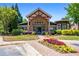 Community clubhouse featuring a stone facade, manicured landscaping, and colorful flowers at 1233 Ashford Creek Ne Park, Atlanta, GA 30319