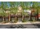 Townhome exteriors with multi-car garages, balconies, brick accents, and mature trees at 1233 Ashford Creek Ne Park, Atlanta, GA 30319