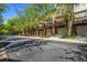 Townhome exteriors with multi-car garages, balconies, brick accents, and mature trees at 1233 Ashford Creek Ne Park, Atlanta, GA 30319