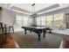 Game room with a pool table, bar seating, wainscoting, and abundant natural light at 1233 Ashford Creek Ne Park, Atlanta, GA 30319