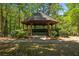 Community gazebo surrounded by lush greenery and mature trees at 1233 Ashford Creek Ne Park, Atlanta, GA 30319