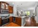 Open-concept kitchen and living room features hardwood floors and stainless steel appliances at 1233 Ashford Creek Ne Park, Atlanta, GA 30319