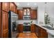 Charming kitchen features stainless steel appliances, granite counters, and ample cherry wood cabinetry at 1233 Ashford Creek Ne Park, Atlanta, GA 30319