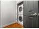 Small laundry closet features stacked washer and dryer at 1233 Ashford Creek Ne Park, Atlanta, GA 30319