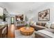 Open-concept living space featuring a comfortable sofa, stylish decor, and a glimpse of the kitchen at 1233 Ashford Creek Ne Park, Atlanta, GA 30319