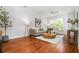 Cozy living room with hardwood floors, neutral color palette, and a comfortable sectional sofa at 1233 Ashford Creek Ne Park, Atlanta, GA 30319