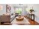 Inviting living room featuring a plush sectional sofa, round coffee table, and hardwood floors at 1233 Ashford Creek Ne Park, Atlanta, GA 30319