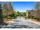 Community entrance featuring gated access, mature trees, and manicured landscaping at 1233 Ashford Creek Ne Park, Atlanta, GA 30319