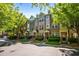 Charming townhomes with varied facades, manicured greenery, and tree-lined street at 1233 Ashford Creek Ne Park, Atlanta, GA 30319