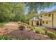 Beautifully landscaped backyard featuring a multi-tiered design with flowering plants and a covered patio area at 1282 Fairhill Ne Ln, Atlanta, GA 30319
