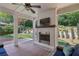 Spacious backyard with a covered patio featuring a brick fireplace and overlooking a well-manicured yard at 1282 Fairhill Ne Ln, Atlanta, GA 30319