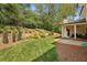 Expansive backyard featuring manicured lawn, mature trees, and a covered porch, great for entertaining at 1282 Fairhill Ne Ln, Atlanta, GA 30319