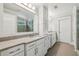 A bright bathroom has a double vanity, a glass shower and coordinating white cabinets at 1282 Fairhill Ne Ln, Atlanta, GA 30319