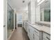 A spacious bathroom has dual sinks, a glass enclosed shower and stone floors at 1282 Fairhill Ne Ln, Atlanta, GA 30319