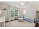 A charming Bedroom offers a white crib, a white chair and lots of natural light at 1282 Fairhill Ne Ln, Atlanta, GA 30319