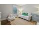 Bright bedroom with jute rug, trundle bed, side chair, and ample natural light at 1282 Fairhill Ne Ln, Atlanta, GA 30319