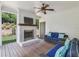 Inviting covered outdoor patio with a brick fireplace, wood plank ceiling, and comfortable seating at 1282 Fairhill Ne Ln, Atlanta, GA 30319