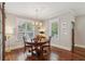 Bright dining room featuring hardwood floors, windows, and classic trim and neutral wall paint at 1282 Fairhill Ne Ln, Atlanta, GA 30319