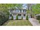 Charming two-story home with a welcoming front porch, well-maintained lawn, and a long private driveway at 1282 Fairhill Ne Ln, Atlanta, GA 30319