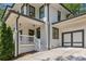 Beautiful white brick home featuring a side entry garage and inviting front porch with staircase entry at 1282 Fairhill Ne Ln, Atlanta, GA 30319