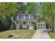 Charming two-story home with a manicured lawn, white brick, black accents, and inviting front porch at 1282 Fairhill Ne Ln, Atlanta, GA 30319