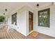 Inviting front porch with white brick, rocking chairs, and wood decking creates a cozy outdoor space at 1282 Fairhill Ne Ln, Atlanta, GA 30319