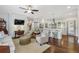 Open concept living room featuring hardwood floors, a ceiling fan, and a seamless view into the kitchen at 1282 Fairhill Ne Ln, Atlanta, GA 30319