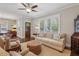 Cozy living room featuring hardwood floors, a ceiling fan, and access to the front door and dining area at 1282 Fairhill Ne Ln, Atlanta, GA 30319