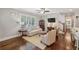 Bright living room showcasing a ceiling fan, hardwood floors, and large windows for ample natural light at 1282 Fairhill Ne Ln, Atlanta, GA 30319