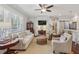 Cozy living room featuring white walls, a ceiling fan, and large windows offering natural light throughout at 1282 Fairhill Ne Ln, Atlanta, GA 30319