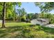 An expansive backyard featuring a lush lawn, trees and a fence, perfect for outdoor activities and relaxation at 1305 Old Woodbine Rd, Atlanta, GA 30319