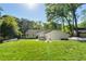 Expansive backyard featuring lush green grass, a well-manicured lawn, and mature trees offering shade and privacy at 1305 Old Woodbine Rd, Atlanta, GA 30319