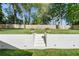 The backyard is showcased with a manicured lawn, brick retaining wall, and lush greenery, providing a private and peaceful space at 1305 Old Woodbine Rd, Atlanta, GA 30319