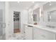 Bright bathroom with marble floors, dual sinks, modern lighting, and an entrance to a walk-in closet at 1305 Old Woodbine Rd, Atlanta, GA 30319