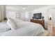 Cozy bedroom with two beds, hardwood floors, a TV, and view into a sunroom at 1305 Old Woodbine Rd, Atlanta, GA 30319