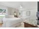 Bright bedroom with two beds, hardwood floors, windows with a view, and a ceiling fan at 1305 Old Woodbine Rd, Atlanta, GA 30319