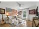 Charming bedroom with a ceiling fan, beautiful artwork, a large window, and hardwood floors at 1305 Old Woodbine Rd, Atlanta, GA 30319