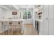 Spacious kitchen featuring a large island with seating, built-in wine cooler, and hardwood floors at 1305 Old Woodbine Rd, Atlanta, GA 30319