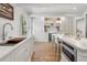 Bright kitchen with a large island, stainless steel appliances, open shelving, and hardwood floors at 1305 Old Woodbine Rd, Atlanta, GA 30319