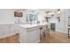 Elegant kitchen with a large island, stainless steel appliances, built-in beverage cooler and hardwood floors at 1305 Old Woodbine Rd, Atlanta, GA 30319