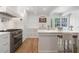 Gourmet kitchen showcasing a stainless steel range, large island, hardwood floors and natural light at 1305 Old Woodbine Rd, Atlanta, GA 30319
