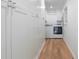 Well-lit laundry room with hardwood floors, washer, dryer, and built-in storage cabinets at 1305 Old Woodbine Rd, Atlanta, GA 30319
