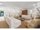 Open living room with a fireplace, sofas, and view of dining area at 1305 Old Woodbine Rd, Atlanta, GA 30319
